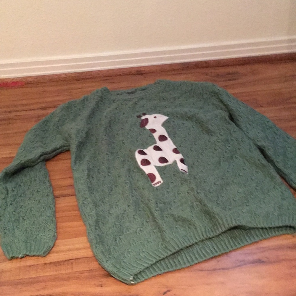Green sweater with giraffe on it